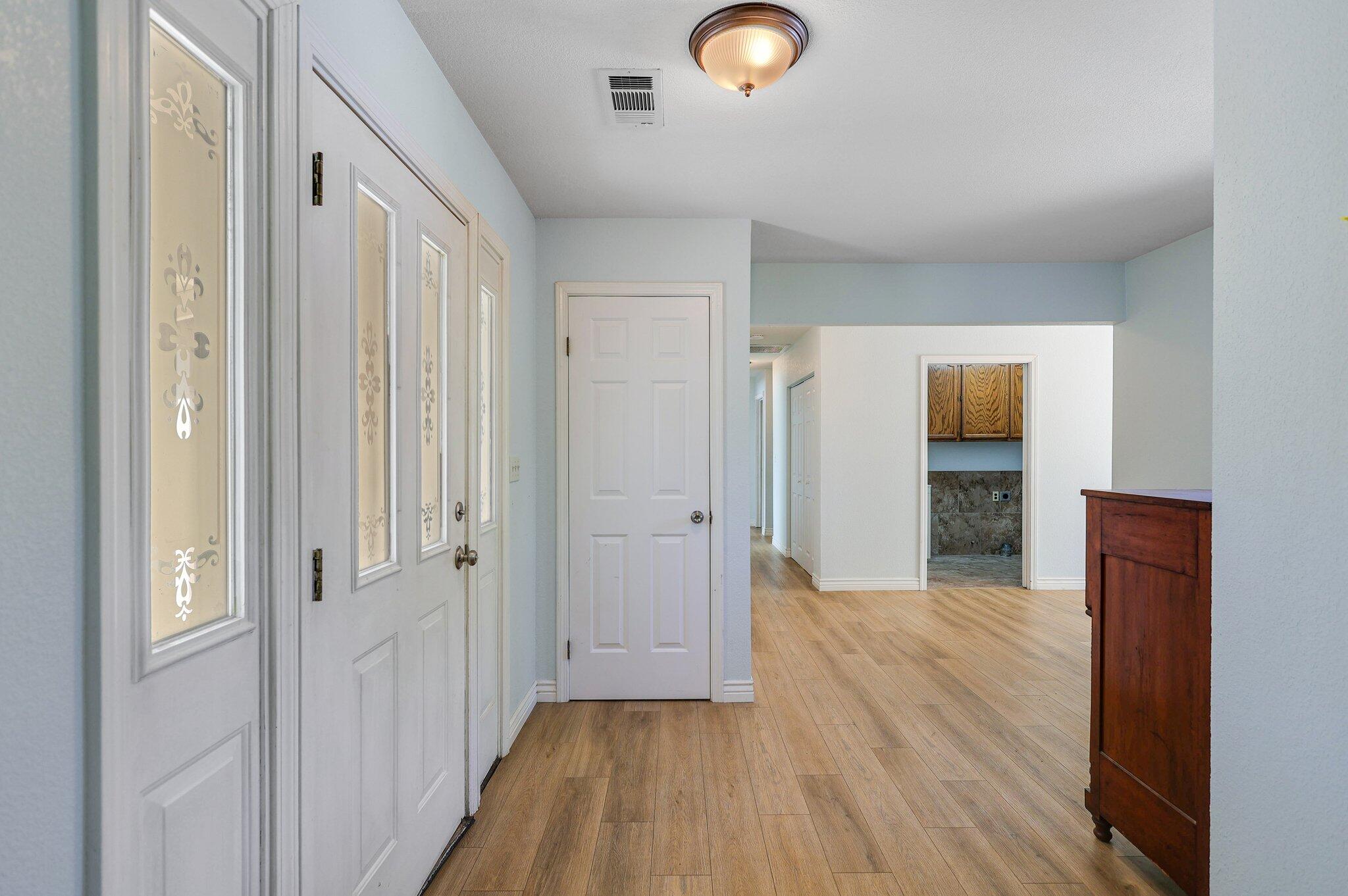 20727 Old Alturas Road Redding, CA 96003 - Photo 6 of 32 a view of a hallway with wooden floor