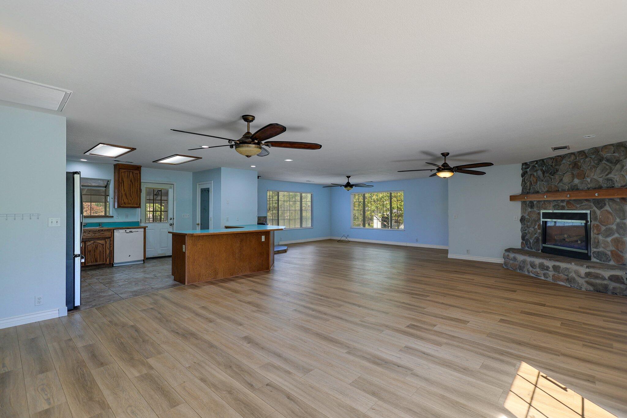 20727 Old Alturas Road Redding, CA 96003 - Photo 7 of 32 a view of a kitchen with a sink and a fireplace