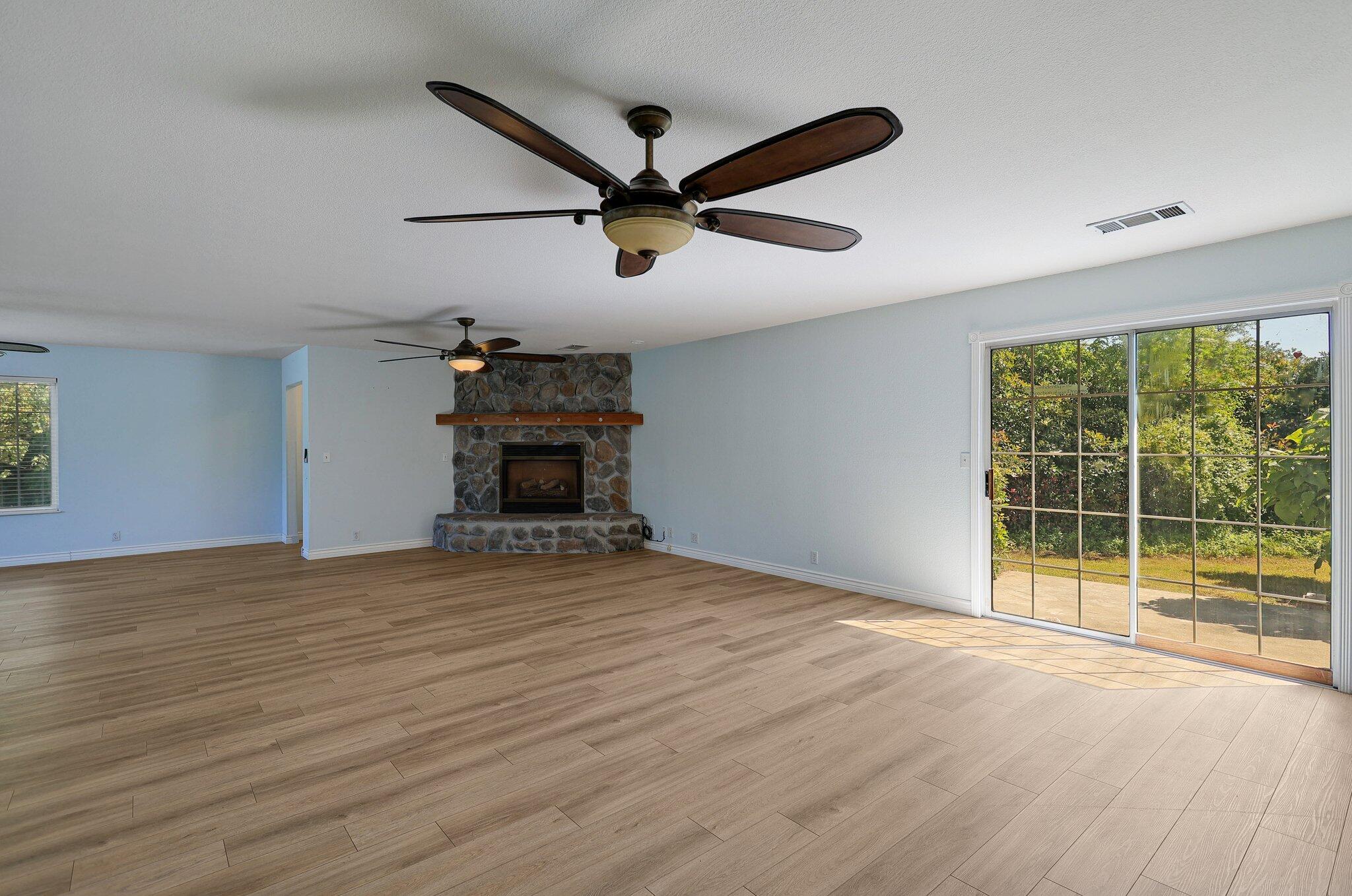 20727 Old Alturas Road Redding, CA 96003 - Photo 8 of 32 a view of empty room with wooden floor and fan