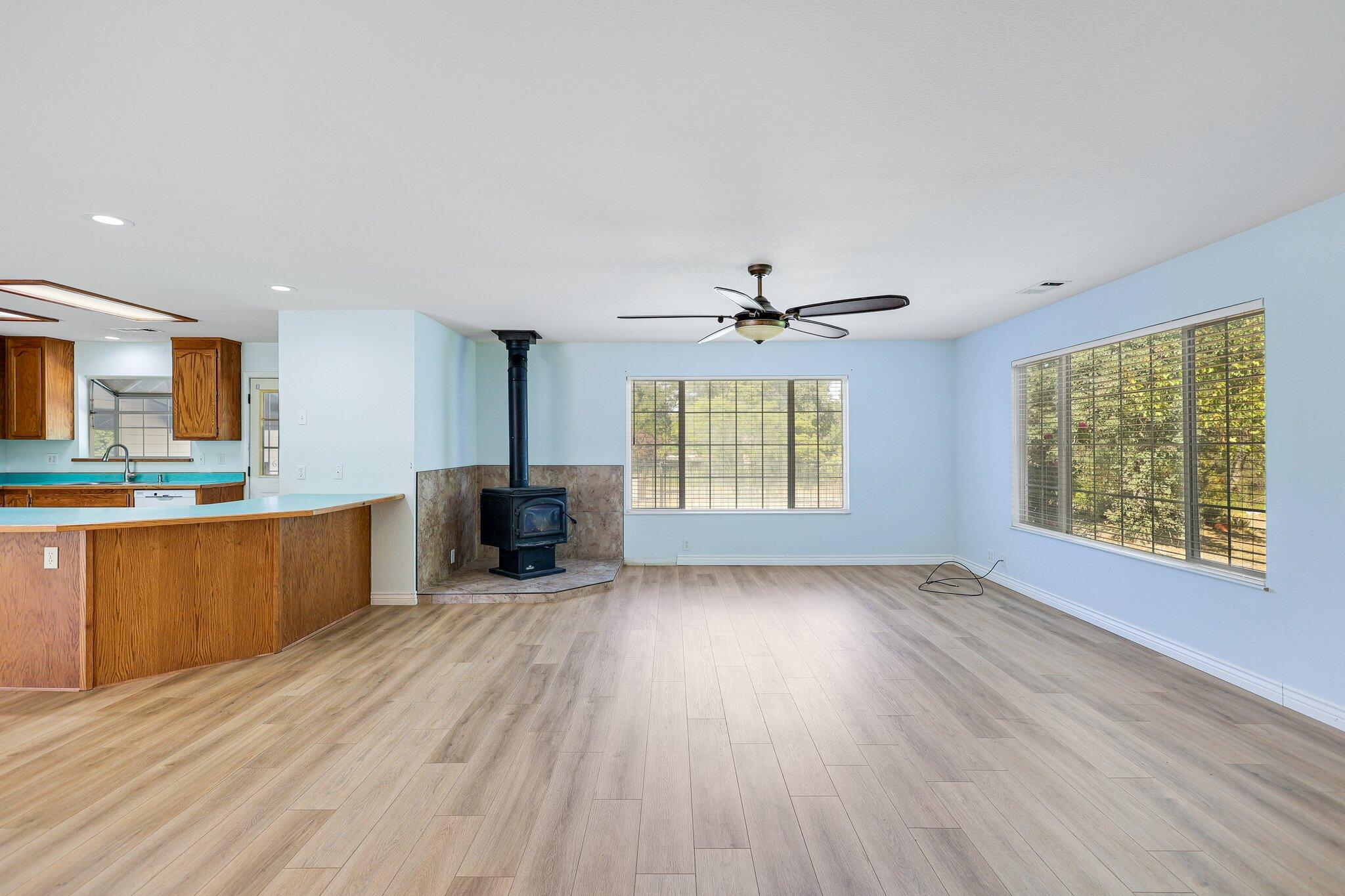 20727 Old Alturas Road Redding, CA 96003 - Photo 9 of 32 a view of an empty room with a kitchen and a window