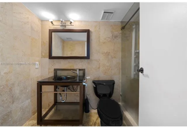 a bathroom with a sink a toilet and mirror