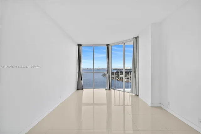 a view of empty room with floor to ceiling window