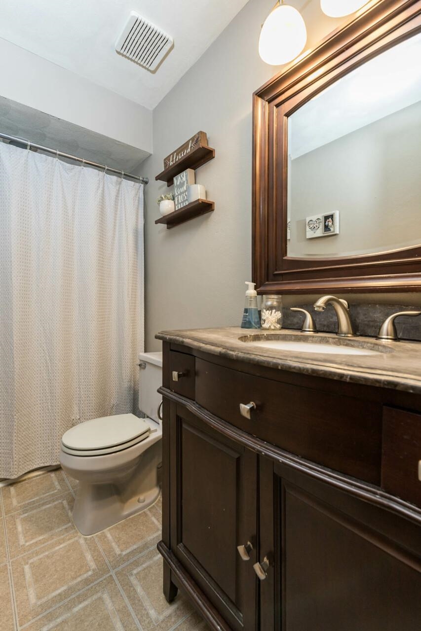 4126 Gloucester Road Roscoe, IL 61073 - Photo 19 of 28 a bathroom with a sink a toilet and a mirror