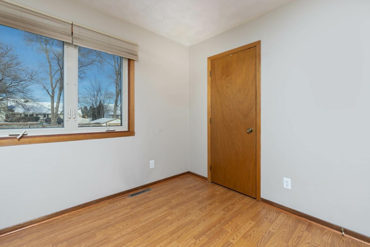 4126 Gloucester Road Roscoe, IL 61073 - Photo 23 of 28 a view of an empty room with wooden floor and a window