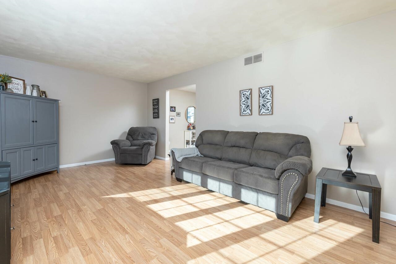 4126 Gloucester Road Roscoe, IL 61073 - Photo 4 of 28 a living room with furniture and a wooden floor