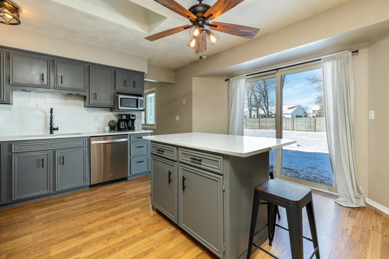 4126 Gloucester Road Roscoe, IL 61073 - Photo 8 of 28 a kitchen with a stove a sink and a refrigerator