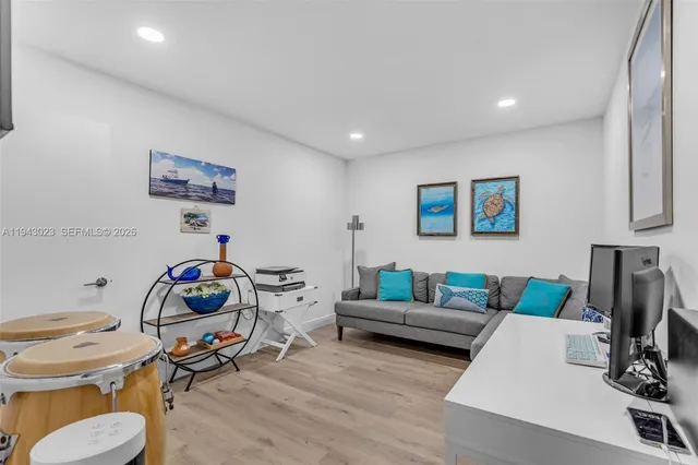 a living room with furniture and a wooden floor