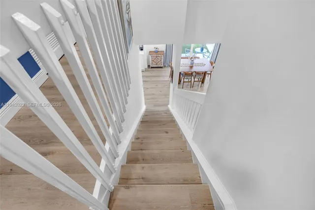 a view of a hallway to a livingroom with furniture and stairs
