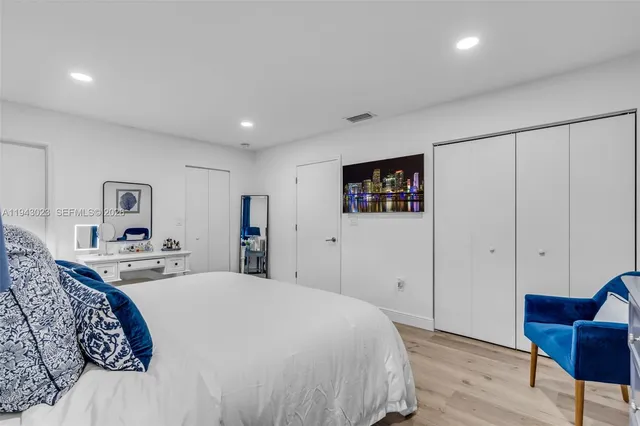 a spacious bedroom with a bed and a couch