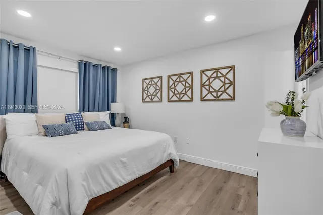 a bedroom with a bed and a painting on the wall