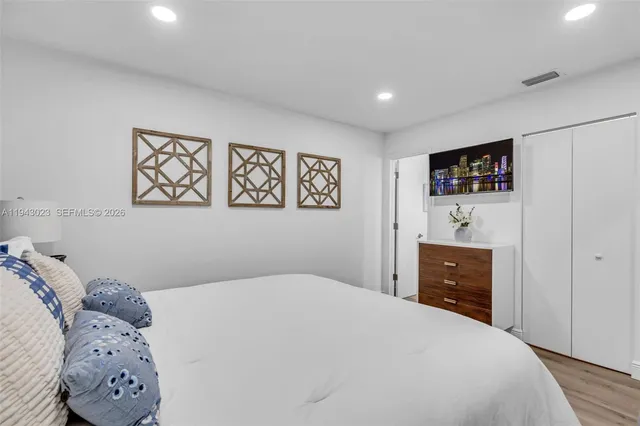 a bedroom with a large bed and a window