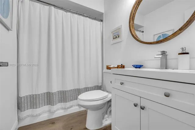 a bathroom with a toilet a sink and a mirror