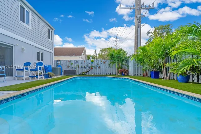 a swimming pool with outdoor seating and yard