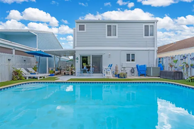 a view of a swimming pool and lounge chair