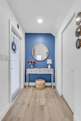 a living room with a furniture and a mirror