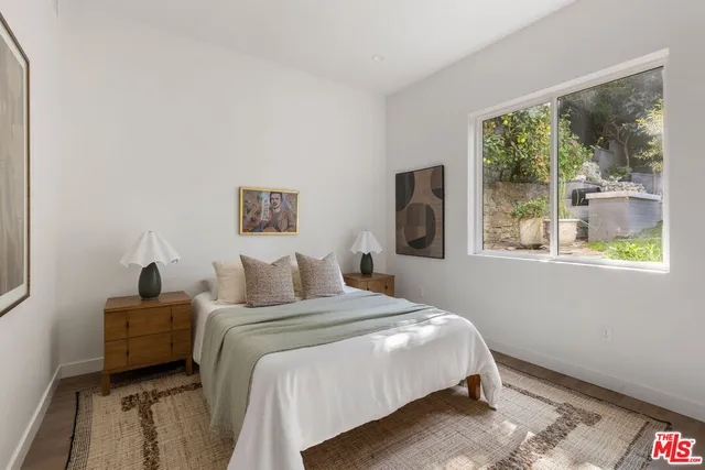 a bedroom with a bed and a window