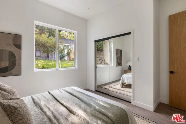 a bedroom with a bed and glass window