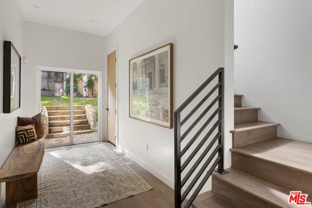 a view of a livingroom with furniture and staircase