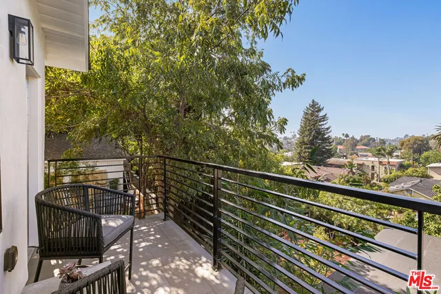 a view of a balcony with wooden floor and fence