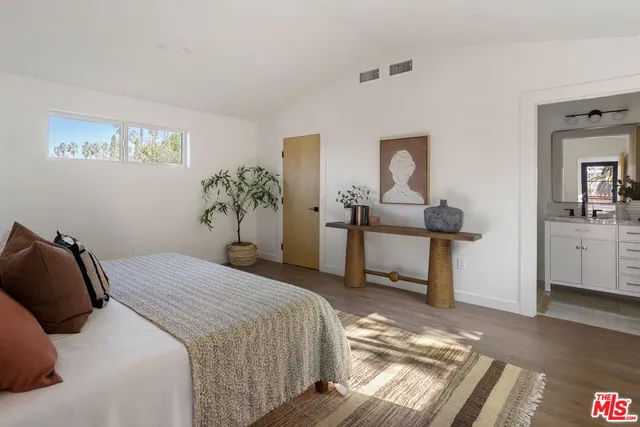 a bedroom with a bed and a table in it