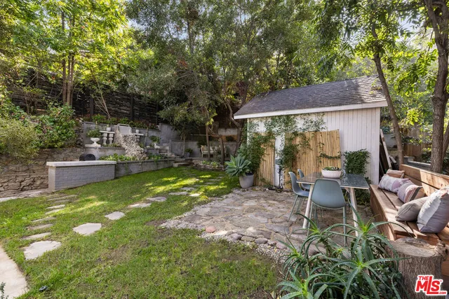 a view of backyard of house with seating space