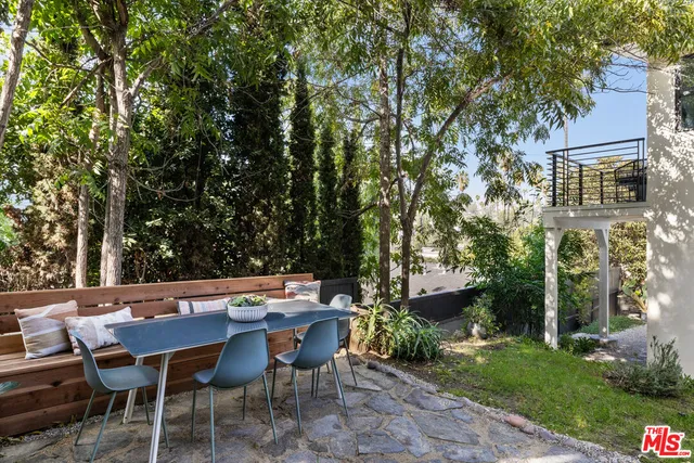 a backyard of a house with table and chairs