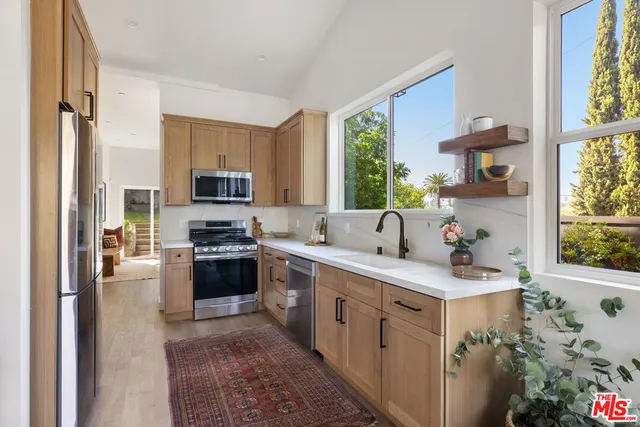 a kitchen with a sink stove and microwave