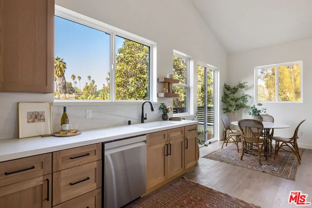 a view of kitchen with sink dining table and chairs