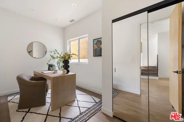 a dining room with furniture and wooden floor