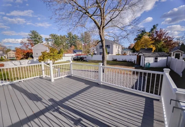 a front view of a house with a big yard and large trees