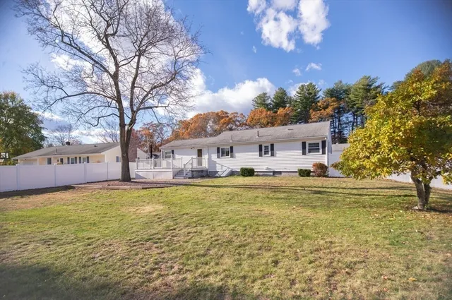 a house view with swimming pool in front of it