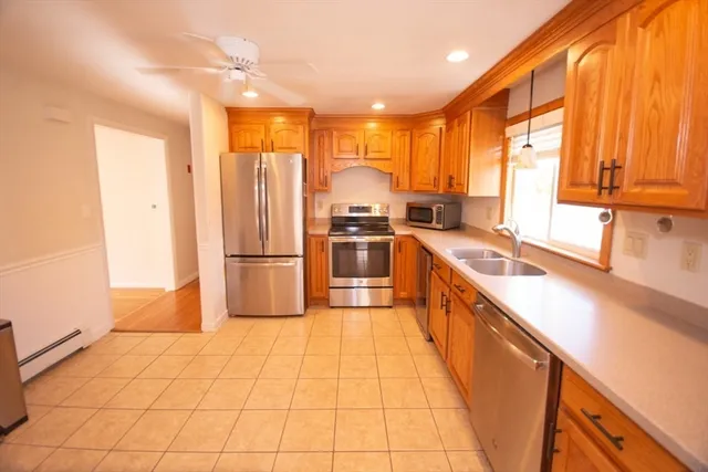 a kitchen with stainless steel appliances granite countertop a sink and a refrigerator
