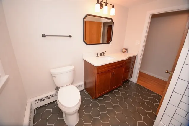 a bathroom with a toilet sink and mirror