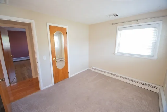 an empty room with windows and closet