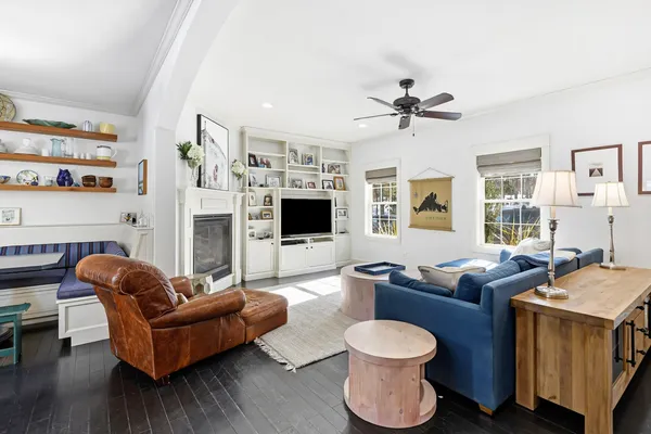 a living room with furniture a flat screen tv and a fireplace