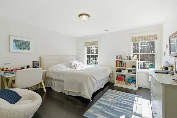 a bathroom with a double vanity sink a mirror and a bathtub