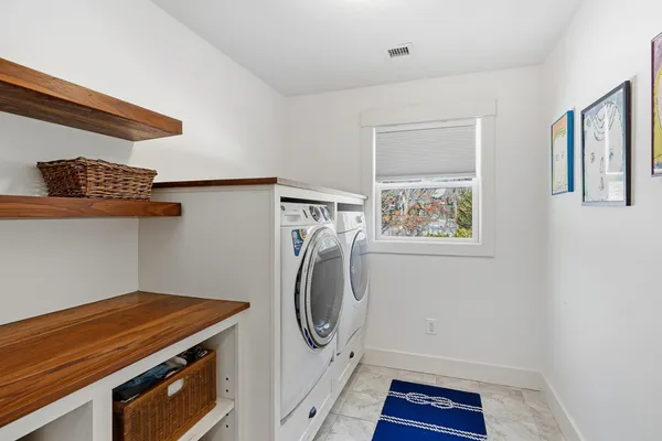 a spacious bathroom with a granite countertop sink a toilet a mirror and shower