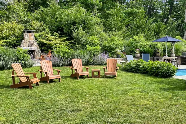 a view of a house with backyard sitting area and garden