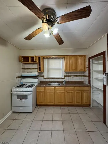 a kitchen with stainless steel appliances granite countertop a stove and a refrigerator