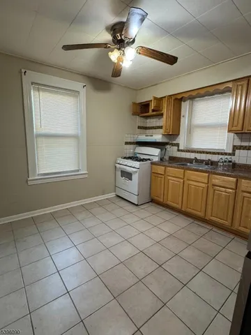 a kitchen with stainless steel appliances granite countertop a sink cabinets and window