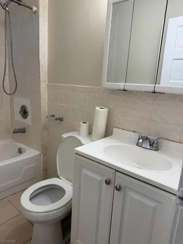 a bathroom with a sink a toilet and bathtub
