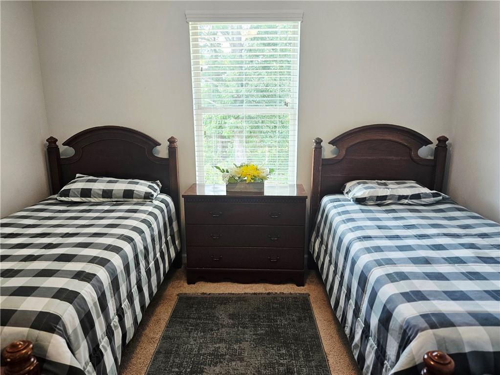 110 Halibut Circle Covington, GA 30016 - Photo 11 of 15 a bedroom with a bed and a lamp next to a window
