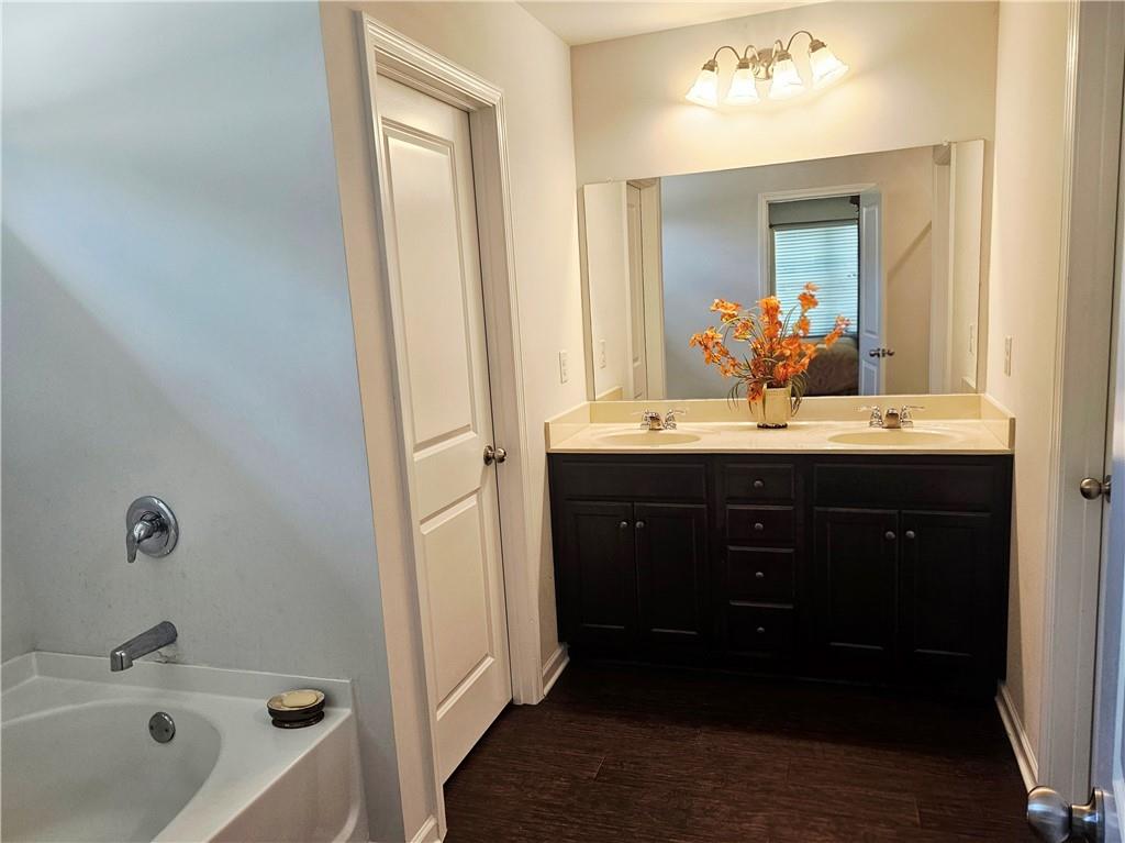 110 Halibut Circle Covington, GA 30016 - Photo 12 of 15 a bathroom with a tub sink and mirror