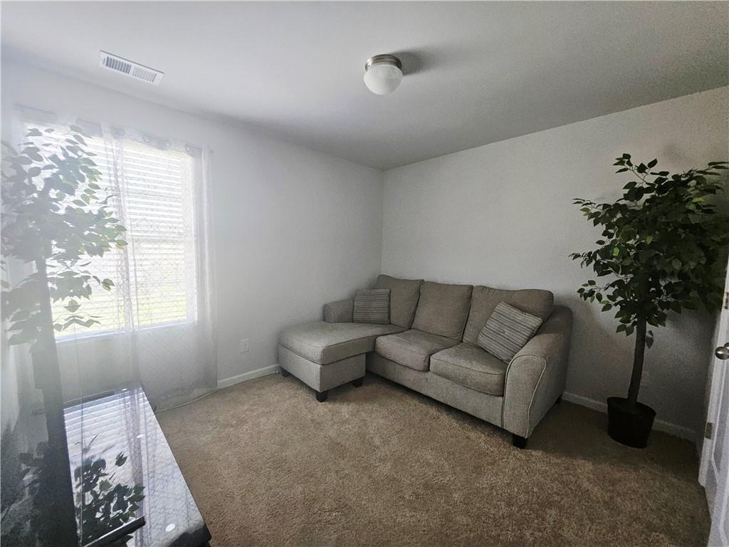 110 Halibut Circle Covington, GA 30016 - Photo 13 of 15 a living room with furniture and a potted plant