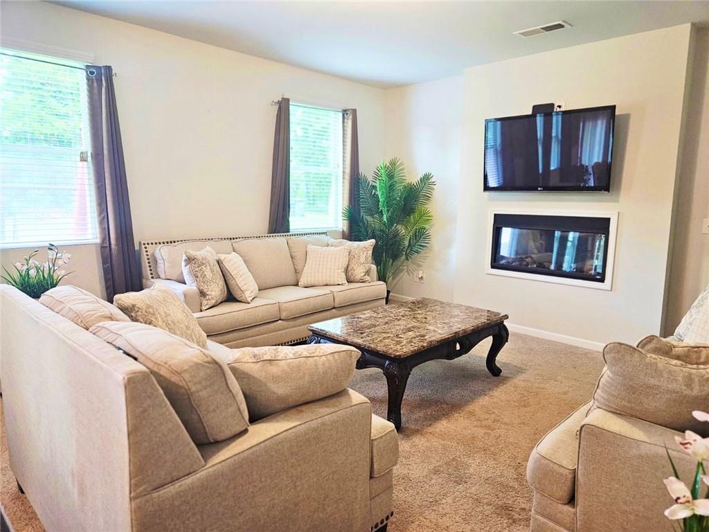 110 Halibut Circle Covington, GA 30016 - Photo 2 of 15 a living room with furniture and a fireplace