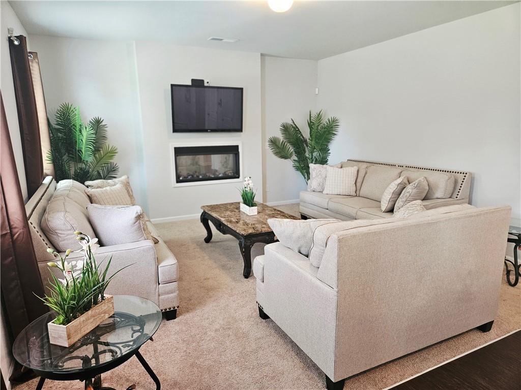 110 Halibut Circle Covington, GA 30016 - Photo 3 of 15 a living room with furniture and a flat screen tv