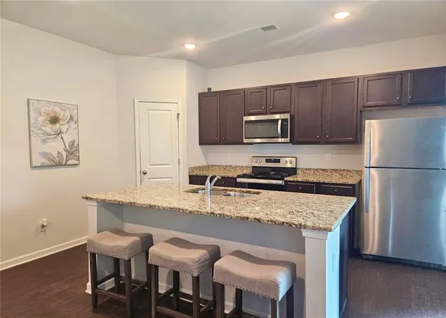 a kitchen with a refrigerator a stove a sink and a refrigerator
