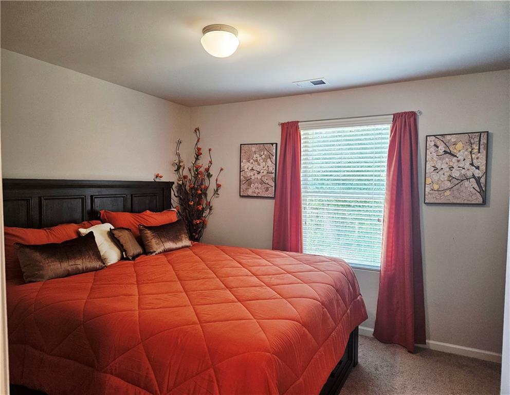 110 Halibut Circle Covington, GA 30016 - Photo 9 of 15 a bedroom with double bed and a window