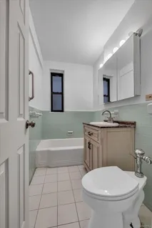 a bathroom with a sink a toilet and bathtub