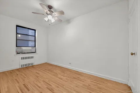 wooden floor in a room next to a window